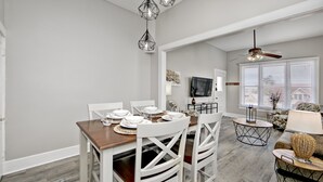 A dining area with a wooden table set for four, white chairs, and a ceiling fan. - 2 blocks to Downtown Square ! (Prescott)