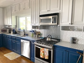 Enjoy cooking in this well-equipped kitchen with a stainless steel stove, microwave, and dishwasher.