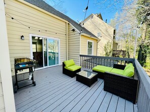 A deck with outdoor furniture, a grill, and a sliding glass door. - 2 Bedroom Townhome- Fire 🔥 Pit - New Renovation (Kennesaw)