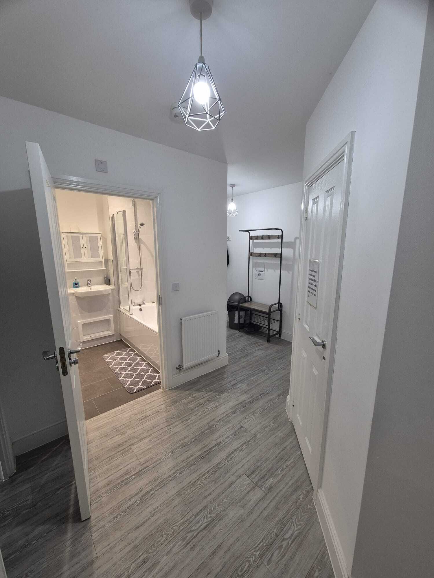 Bathtub, hair dryer, slippers, towels