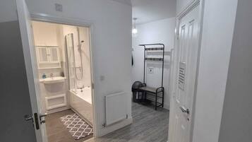 Bathtub, hair dryer, slippers, towels