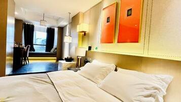 A hotel room with a bed, a desk, and a chair.