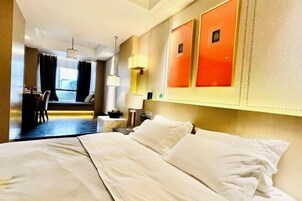 Una habitación de hotel con una cama, un escritorio y una silla.