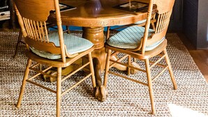 A wooden dining table with four chairs, a blue wall with vertical paneling, and a framed picture of a fox. - Mountaintop cabin in Pearisburg! (Pearisburg)