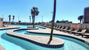 A swimming pool with a tiled edge, palm trees, lounge chairs, and a '3 FT NO DIVING' sign.