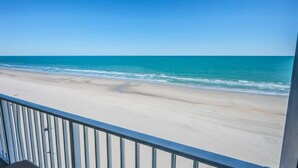 A beach view from a balcony with a railing. - New Direct Ocean View, Exclusive Sand Beach Club! (Myrtle Beach)