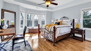 A bedroom with a bed, a desk, a chair, a ceiling fan, and large windows. - Adorable Atlanta gem near downtown with WiFi, backyard, & excellent location (Atlanta)