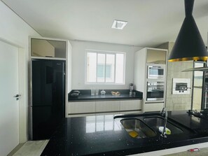 Luxury Apartment | Private kitchen | Full-size fridge, microwave, oven, toaster