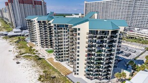 A high-rise hotel with multiple balconies, a pool, and a beach view. - Lands' End @ Sunbird :5th floor Sleeps 4 Gulf Front (Panama City)