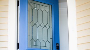 A blue door with a glass panel and a keypad lock. - Historic Home Near Downtown & UW (Laramie)