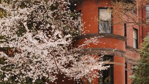 A red brick building with a round tower and multiple windows. - Dupont Circle Embassy Inn by FOUND (Washington)