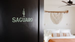 A black wall with the logo "SAGUARO" and a blurred room with a bed and a ceiling fan. - Type A? This is your place! The Verde House by Vacay in Tucson (Tucson)