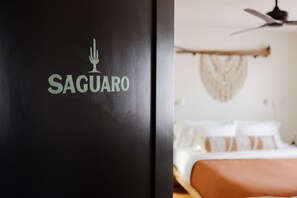 A black wall with the logo "SAGUARO" and a blurred room with a bed and a ceiling fan. - Type A? This is your place! The Verde House by Vacay in Tucson (Tucson)