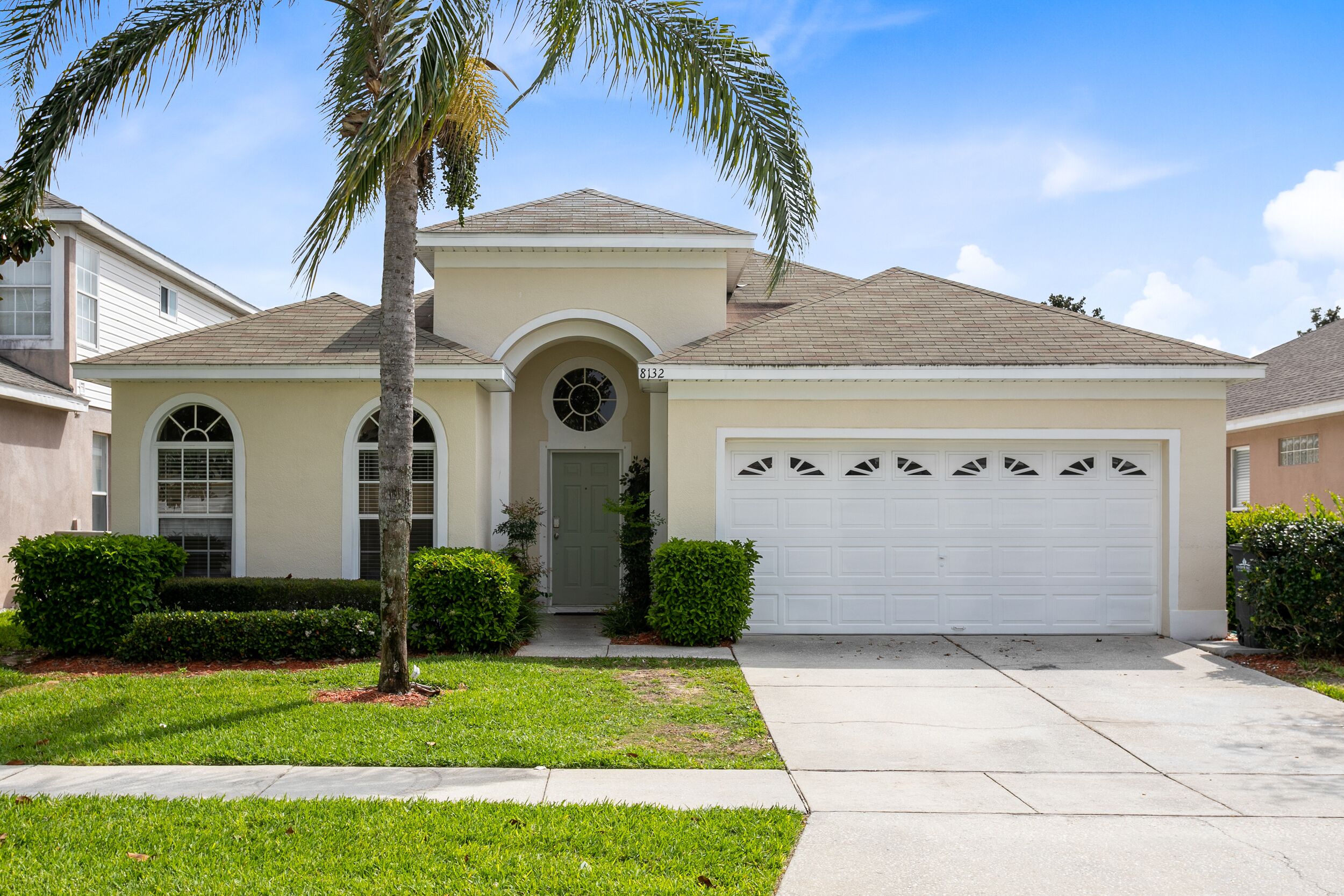 A single-story house with a garage, a front door, and a small porch.