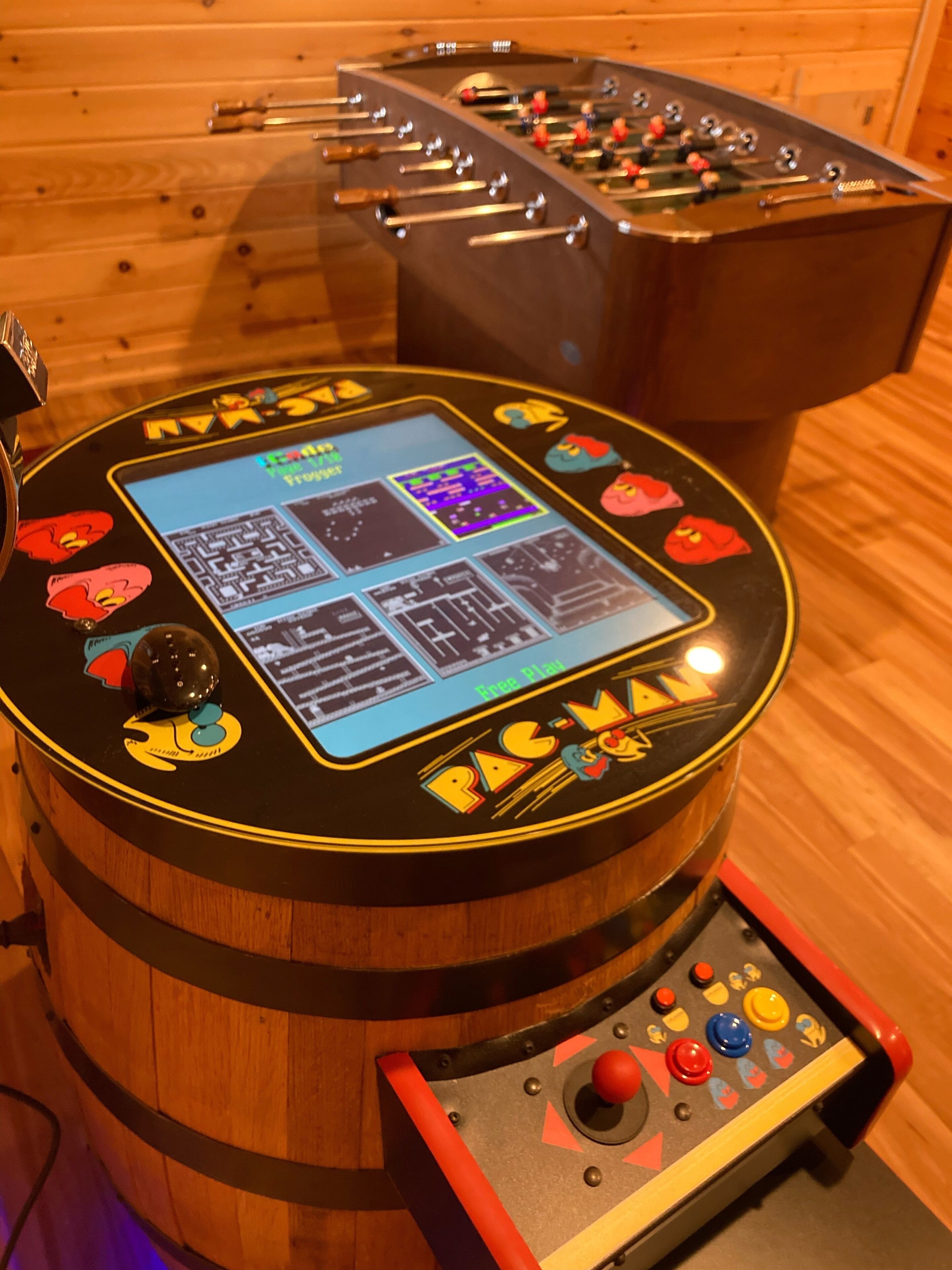 A foosball table with a digital scoreboard and joystick control.