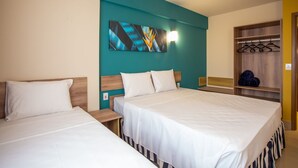 A hotel room with two beds, a teal accent wall, a wooden headboard, and a wardrobe with hanging space. - Solar das Águas Park Resort - Olimpia SP (Olímpia)