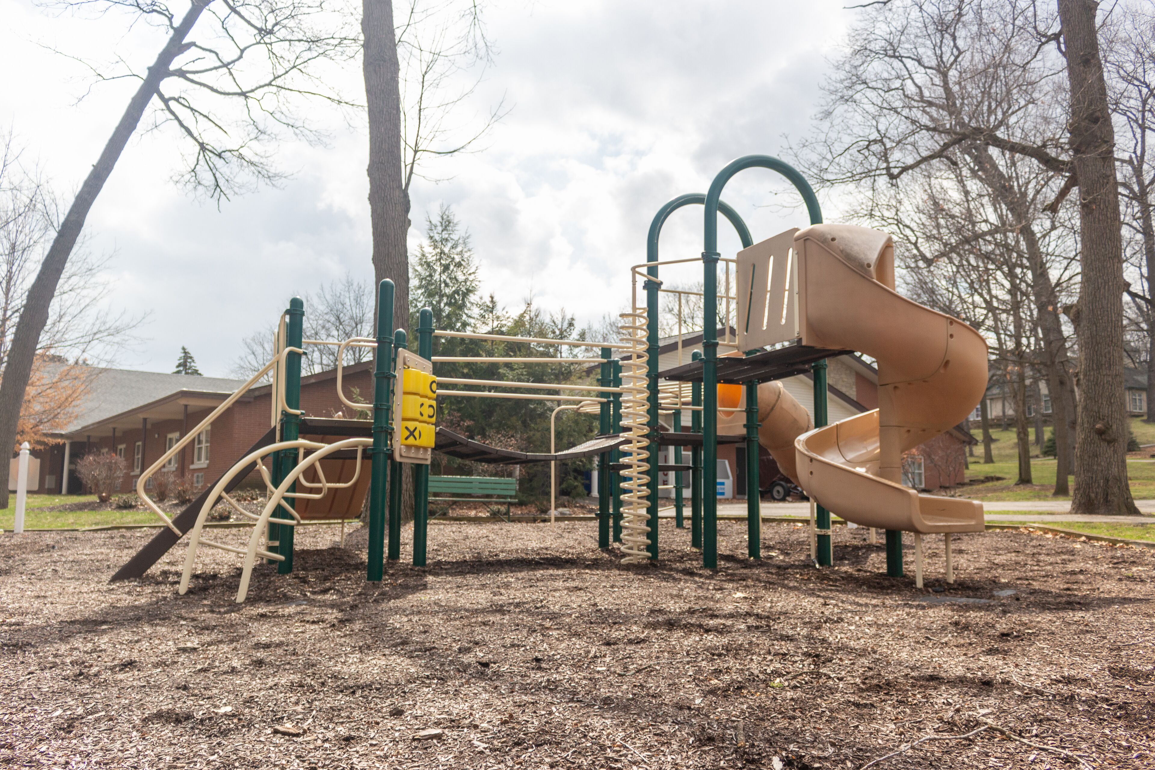 A playground with a slide and climbing structures.