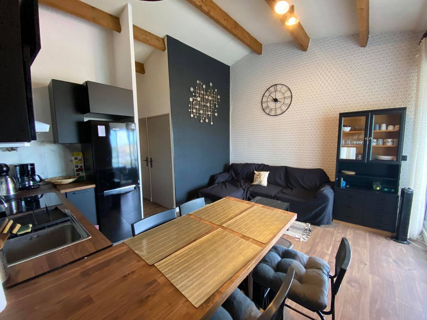 A compact living space with a kitchen, dining area, and seating area.