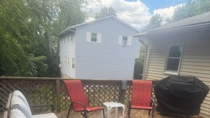 A covered patio with outdoor furniture, including a sofa, chairs, and a table. - Your Penn State Destination (State College)
