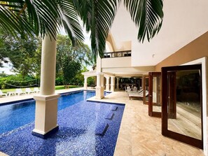 A pool area with a clear view of the surrounding greenery and a covered seating area. - Cocotal Las Brisas Luxury 6BR Villa for Families, Groups & Events (Punta Cana)