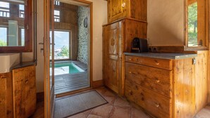 A wooden kitchen with a wooden cabinet, a sink, and a window. - 'Ferme de Faustine' Apartment with Shared Heated Pool and Wi-Fi (Saint-Gervais-les-Bains)