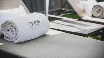 A towel with a logo on a lounge chair.