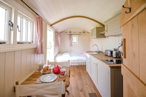 Enjoy a compact retreat with a kitchenette and sleeping area, perfect for a cozy stay.