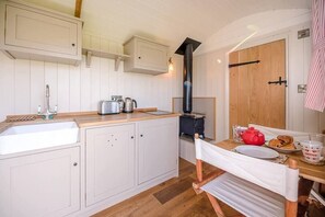 Kitchen area with a stove, sink, and cooking essentials.