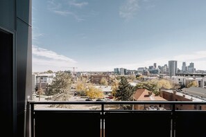 A cityscape view from a balcony with buildings and trees in the foreground. - City Views | Lifestyle Loft | Zuni Lofts (Denver)