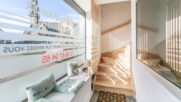 A modern interior with a view of a historic building outside.