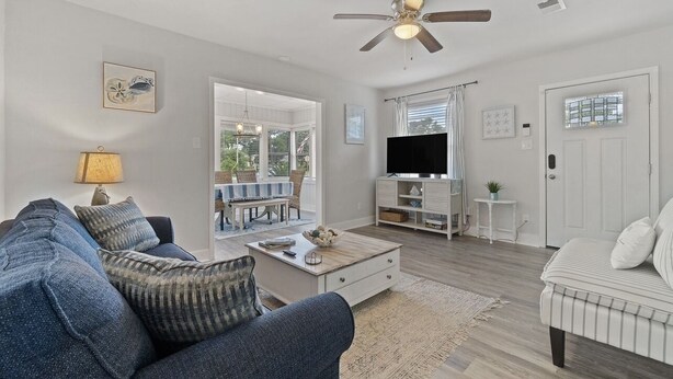 A living room with a sofa, coffee table, TV stand, and ceiling fan. - 2 for 1❗️2 separate houses (Pensacola)