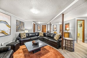 Relax in this stylish living room with a comfortable sofa, coffee table, and side table.