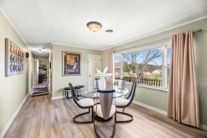 Enjoy meals in this dining area with a round table and four chairs, surrounded by a view of the outdoors.