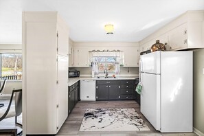 Enjoy cooking in this well-equipped kitchen with appliances and ample natural light.