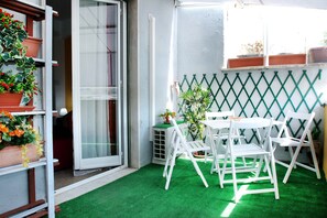 A balcony with artificial green turf, white chairs, and potted plants. - Apt. near S.Peter & beautiful terrace (Roma)