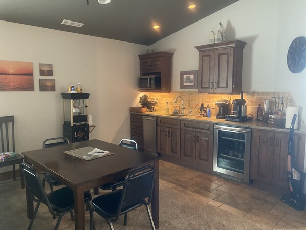 A kitchen with wooden cabinets, a microwave, a coffee maker, and a dishwasher.