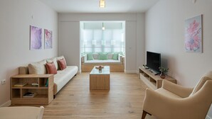 A modern living room with a sofa, a coffee table, a TV, and a bookshelf. - Cigdem'inn Sigacik (Seferihisar)