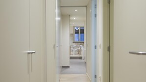 A hallway leading to a kitchen with a dining area. - Bravissimo Cort Reial 2A, beautifully renovated (Girona)