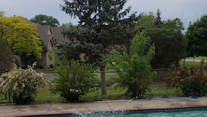 A swimming pool with a person swimming and another on a float. - EAA Spacious home w/ Pool  / Sleeps 10 (Winneconne)