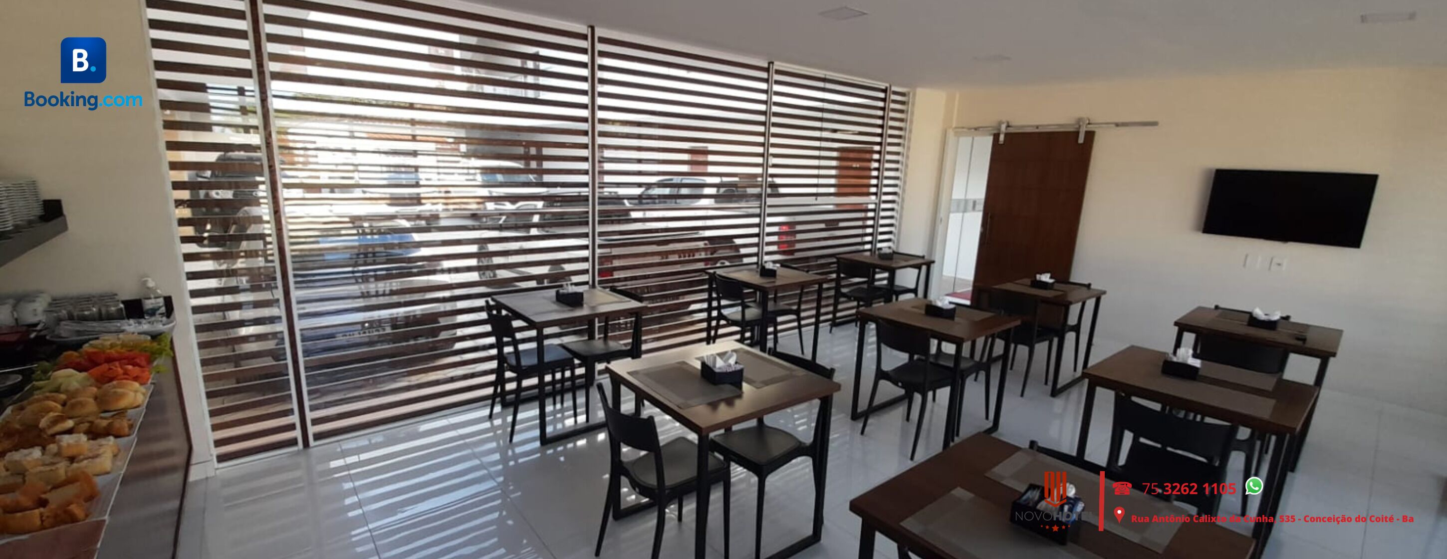 A modern dining area with tables and chairs, a buffet with various food items, and a large window with blinds.