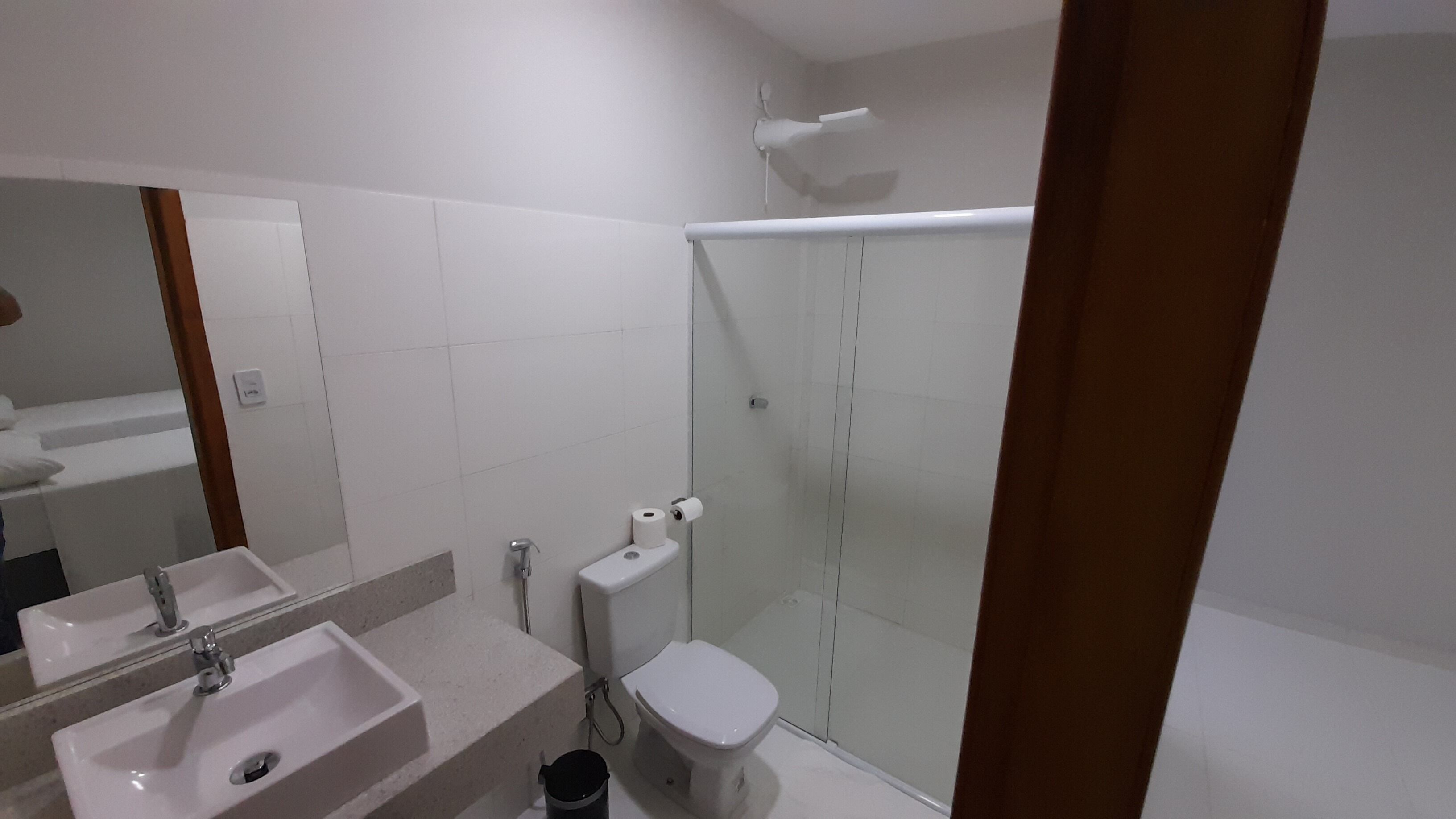 A bathroom with a sink, toilet, and shower.