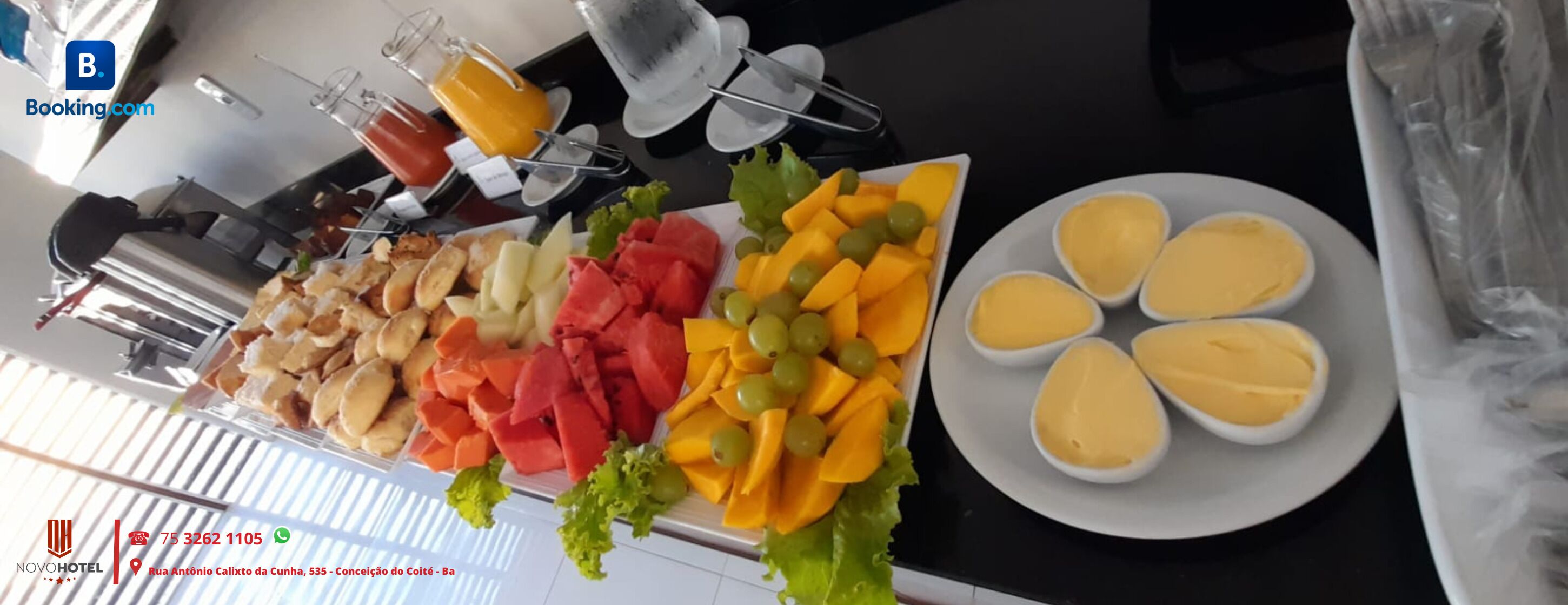 Una mesa de buffet con diversas frutas, verduras y un plato de huevos.