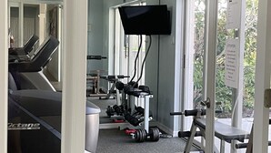 A gym with treadmills, dumbbells, and exercise equipment. - Beautifully updated, gated community, minutes from the gulf beaches (Bonita Springs)