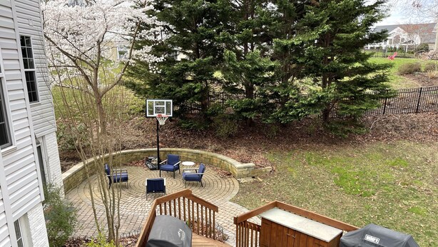 A deck with outdoor seating, a basketball hoop, and a covered grill area. - Stunning, spacious family home, adjacent to DT Annapolis, (Arnold)