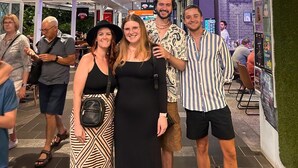 A group of people standing in front of 'The ESPY Hostel' sign, with a 'Millhone' sign above. - The Espy Hostel (Cairns)