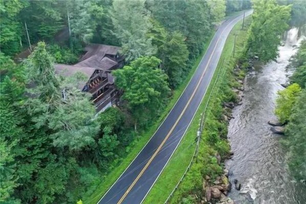 A winding road through a forested area with a bridge over a river. - RR Vacation on the Rocks (Blue Ridge)