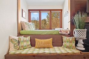 Relax in this inviting room with a bench and large window offering a view.