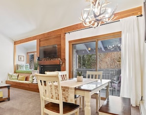 Cozy living room with a fireplace, dining area, and comfortable seating.