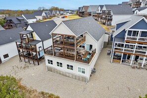 A multi-story building with a balcony and outdoor seating area.