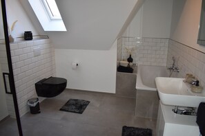 Bathtub, hair dryer, towels, soap